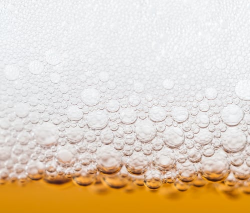 Preview: beer bubbles in a glass of fresh amber beer