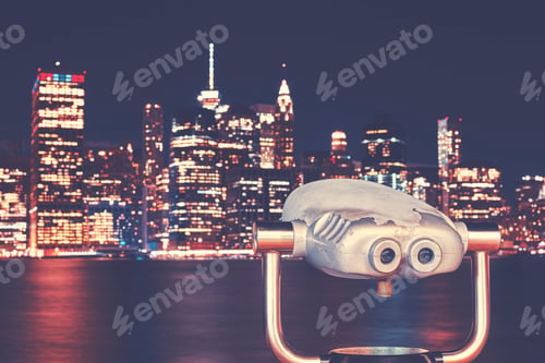 Preview: Vintage toned binoculars with New Your skyline at night, USA.