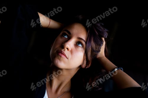 Preview: Portrait of beautiful brunette woman looking up