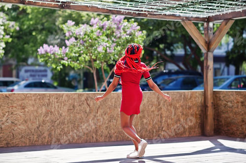 Preview: African american girl in red dress with dreadlocks