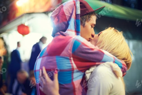 Preview: Their love is vibrant. Shot of an affectionate couple having a good time at an outdoor festival.