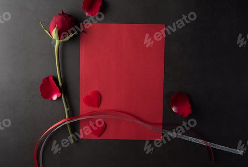 Red Rose, Paper, and Hearts on Black Surface