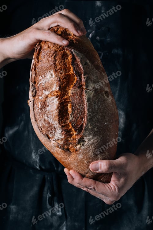 Preview: Man holding homemade rustic bread