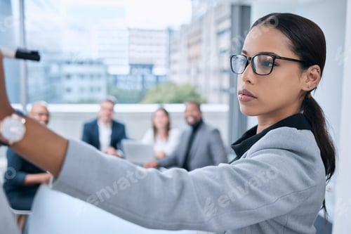 Preview: Shot of a young businesswoman using a whiteboard during a presentation in an office