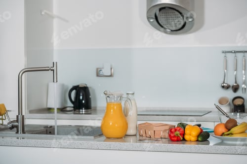 Preview: fruits, vegetables and orange juice with milk on kitchen table