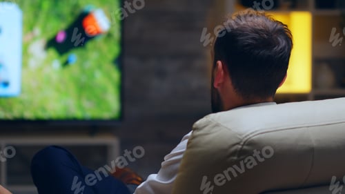 Preview: Back view of businessman taking a sip of beer