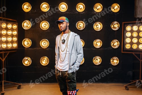 Preview: Black rapper in cap on stage with spotlights