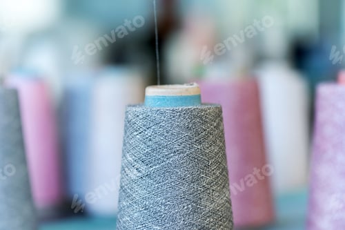 Preview: Close up detail of cashmere wool on a spool in a factory