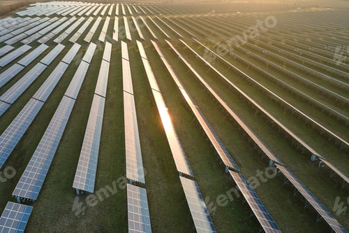 Preview: Aerial view of large sustainable electrical power plant with rows of solar panels