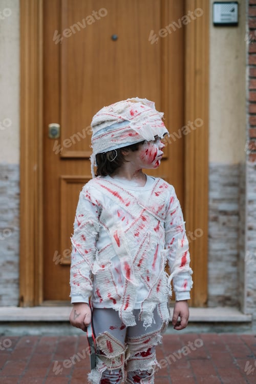 Preview: Little boy dressed in mummy in the street