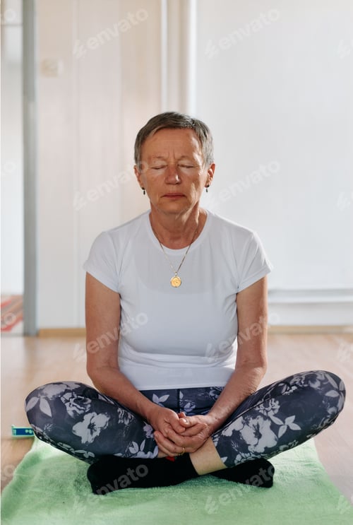 Preview: A senior woman's hand gracefully engages in various yoga poses, embodying the essence of active