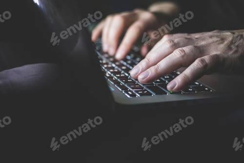 Preview: Mature man using laptop, focus on hands