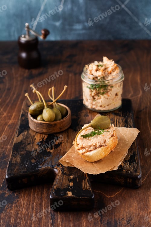 Preview: Sandwich with chicken pate with caper on a dark old board background. Selective focus