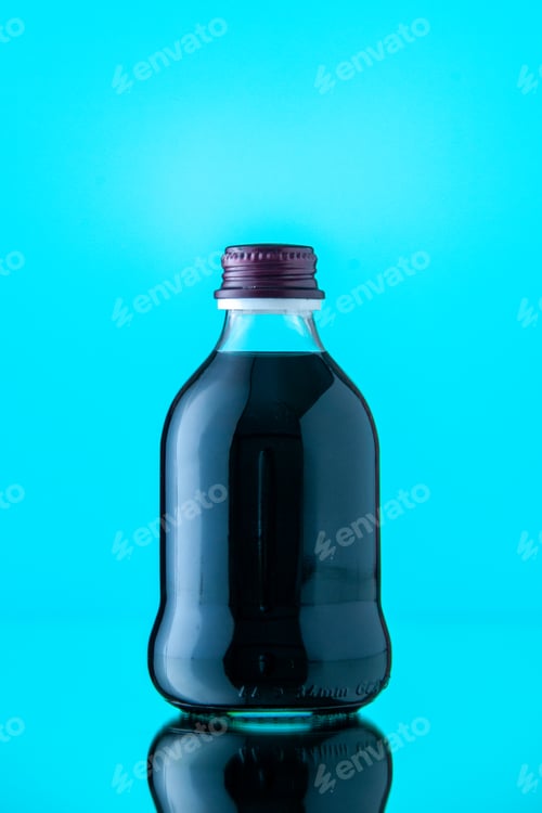 Preview: front view glass bottle with black juice on light blue background