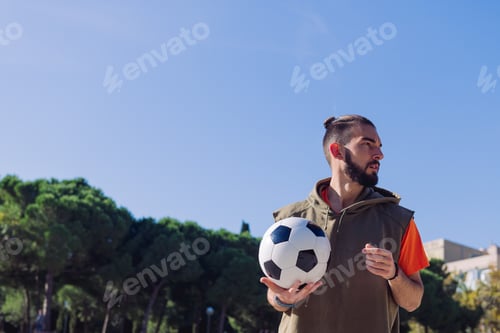 Preview: attractive football player with a ball in his hand