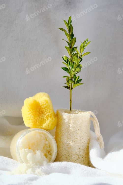 Preview: Scrub, loofah washcloth and organic sea sponge on the background of a terry bath towel.