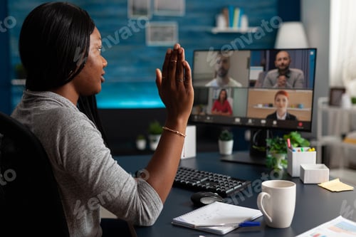 Preview: Person talking to workmates on video call to do teamwork