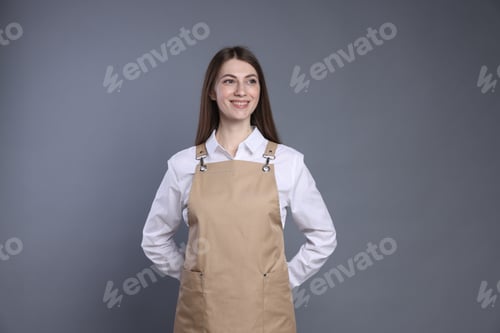 Preview: Portrait of smiling barista on grey background