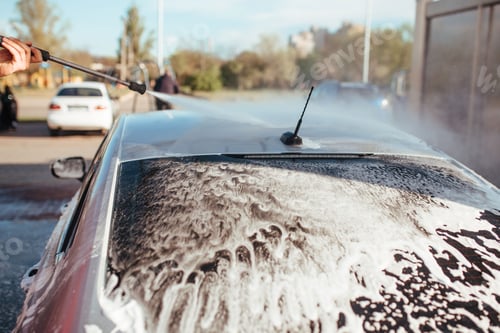 Preview: a man washes a car with a pistol at a self-service car wash