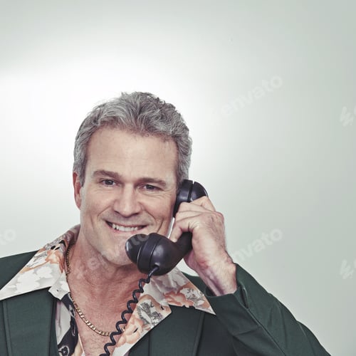 Preview: Cropped studio portrait of a confident mature man talking on an old-fashioned telephone
