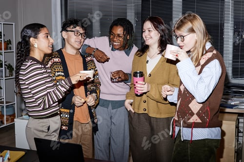 Preview: Group of Diverse Young Adults Socializing and Drinking Coffee in Office