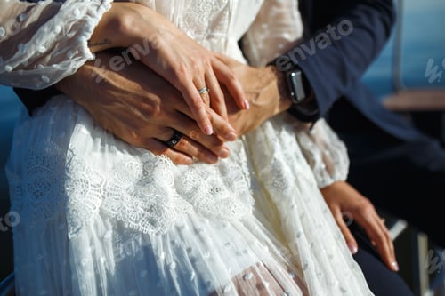 Preview: Bride and groom's hands with elegant wedding rings. Wedding details. Together. Wedding day.