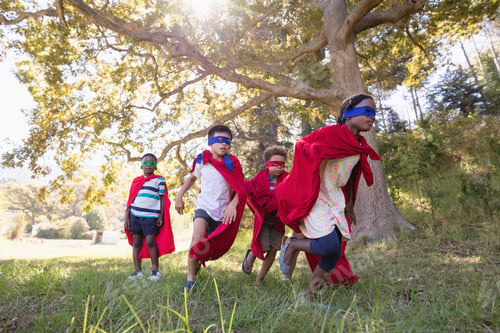 Preview: Group of friends in superhero costumes runing at campsite
