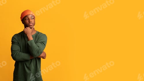 Preview: Interesting Offer. Pensive Young Hipster Guy Touching Chin And Looking Aside