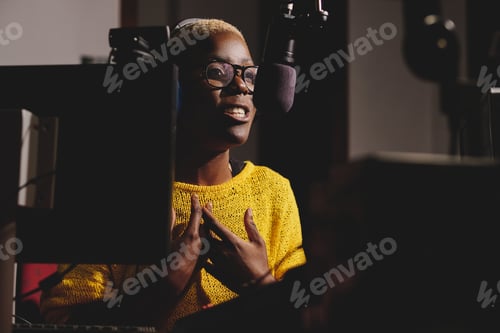 Preview: Black woman speaking into microphone in recording studio