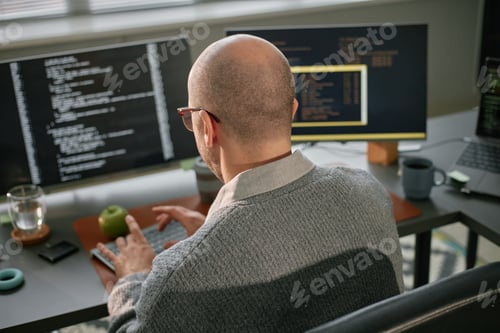 Preview: Middle Aged Caucasian Man Working on Computer Programming in Office