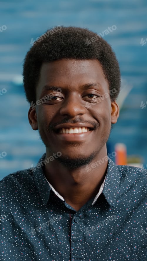 Preview: Close up portrait of charming handsome african american man smiling to camera