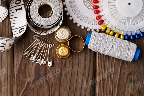 Preview: Threads and sewing accessories on brown wooden table