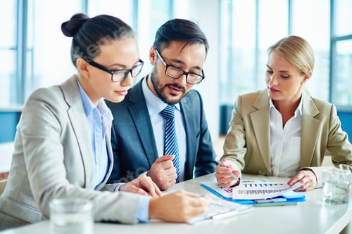 Business Team Collaborates on a Project in Workplace