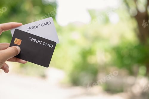 Preview: Credit Card. hand holding credit card with green nature background and copy space concept online sho
