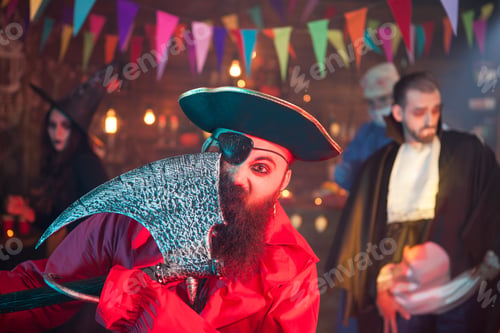 Preview: Portrait of one eyed pirate with axe celebrating halloween