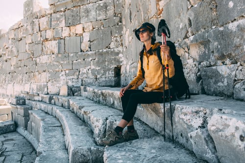 Preview: woman traveler rests, sitting on the steps of the amphitheater. hiking Turkey, Lycian Way, Ksantos