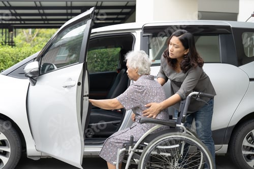 Preview: Caregiver help and support asian elderly woman sitting on wheelchair