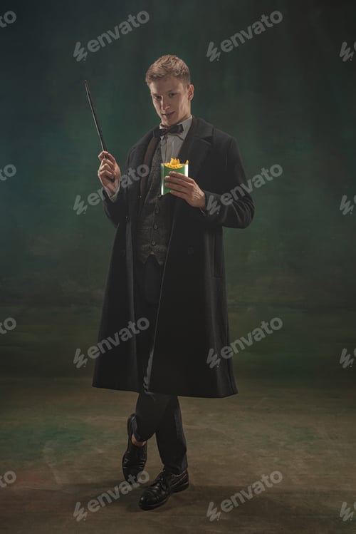 Preview: Young man in art action isolated on dark green background. Retro style, comparison of eras concept