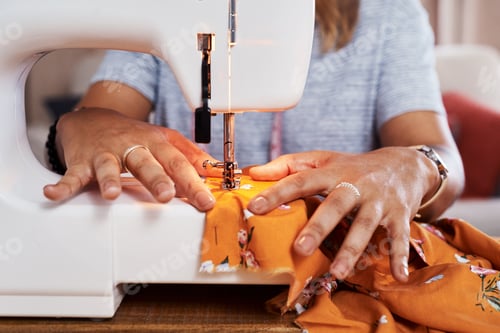 Preview: It was love at first sew. Cropped shot of an unrecognizable woman making a garment at home.