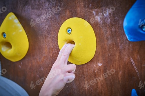 Preview: Climber hand on the bouldering climbing wall round grip