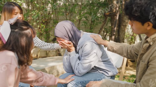 Preview: Muslim woman in trouble sharing story to people sitting in circle at group therapy session.