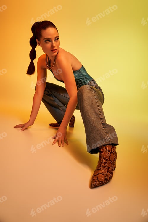Preview: A young woman highlights her stunning makeup and stylish snake print outfit in a pose.