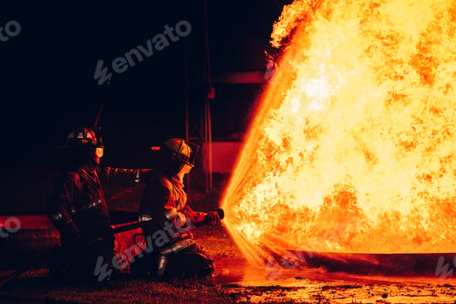 Preview: Fearless Firefighters Battling Blaze with Water and Extinguishers.
