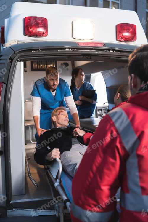 Preview: paramedics moving injured man into ambulance