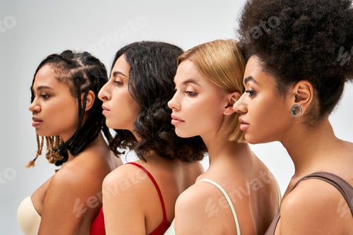 Preview: Multicultural women in colorful bras looking away and posing