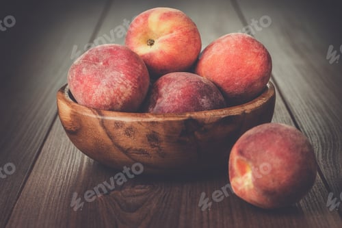 Preview: wooden bowl with some peaches on the table