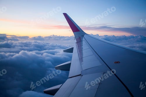 Preview: Morning sunrise with Wing of an airplane.