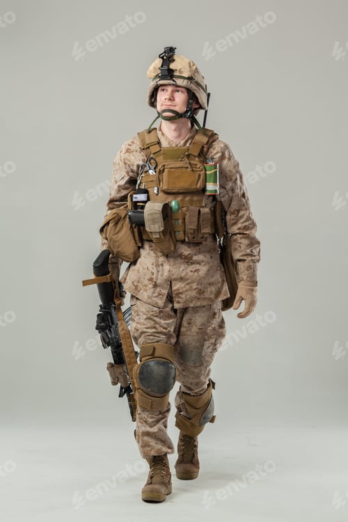 Preview: Soldier wearing military uniform and gear walks forward in a studio setting