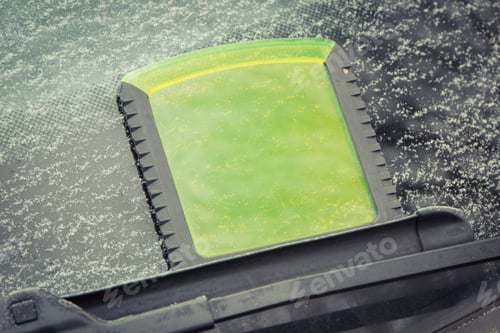 Preview: Scraper using to scrape ice from car window, winter problems in transportation concept