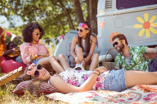Preview: Happy hipsters relaxing on the campsite at a music festival